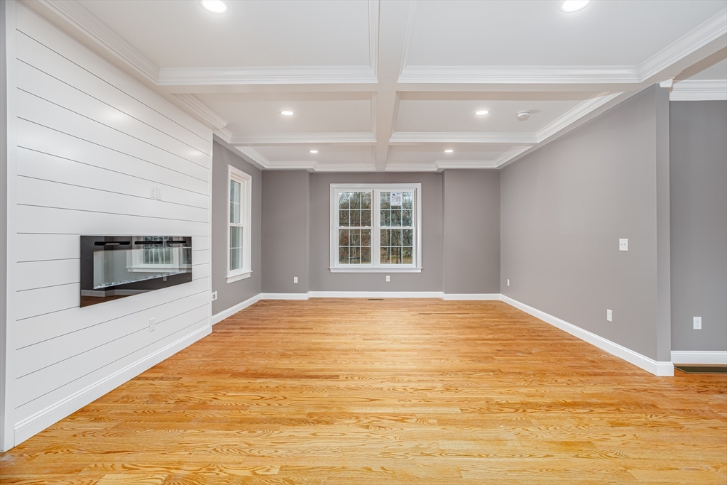 44 Nod Road Groton, MA 01450 - Photo 11 of 42 a view of an empty room with a fireplace and a window