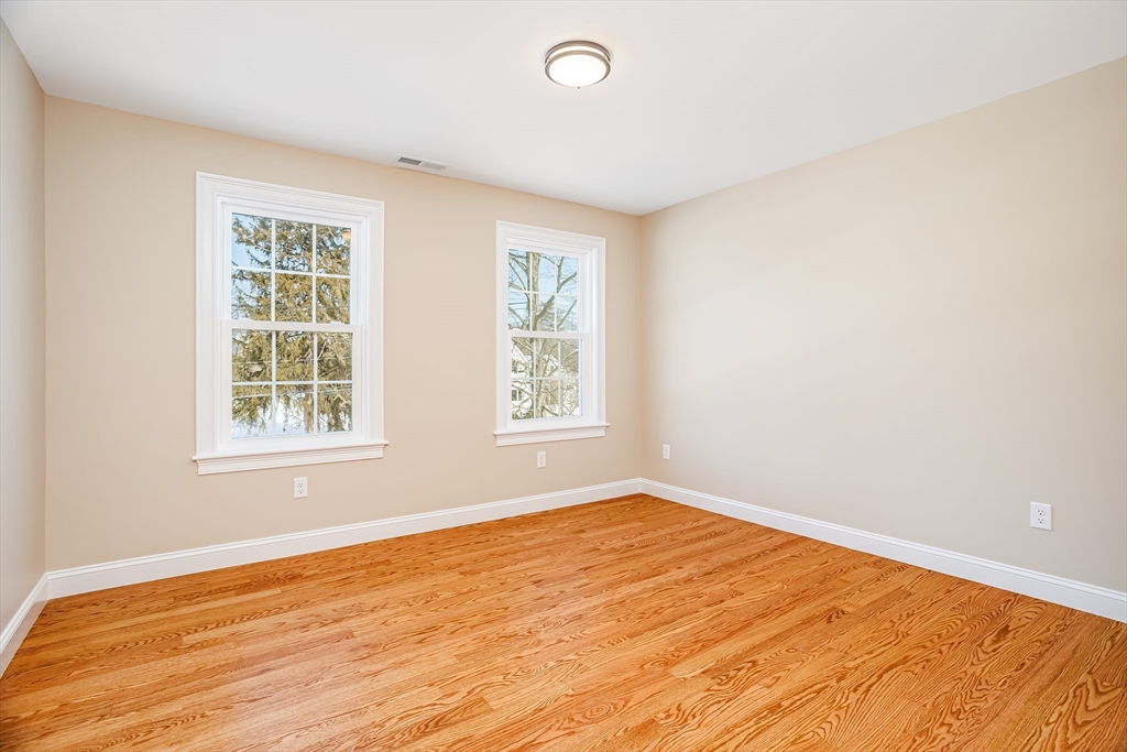 44 Nod Road Groton, MA 01450 - Photo 24 of 42 a view of an empty room with wooden floor and a window