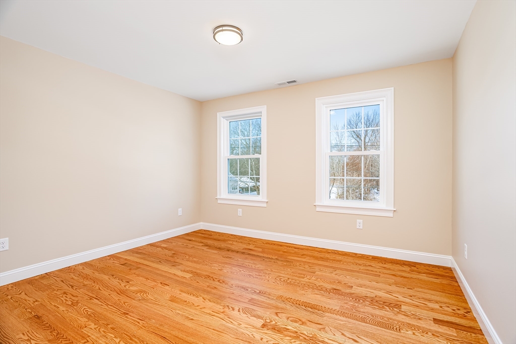 44 Nod Road Groton, MA 01450 - Photo 29 of 42 an empty room with wooden floor and windows
