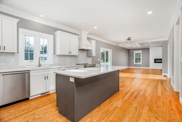 a view of a bedroom with wooden floor and white cabinet