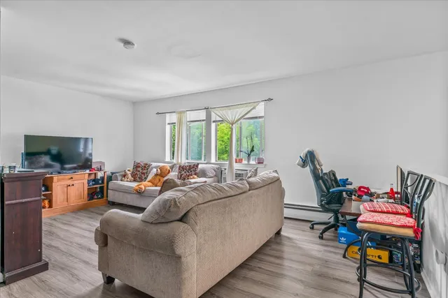 a living room with furniture fireplace and a flat screen tv