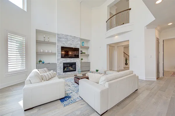 a living room with furniture fireplace and flat screen tv