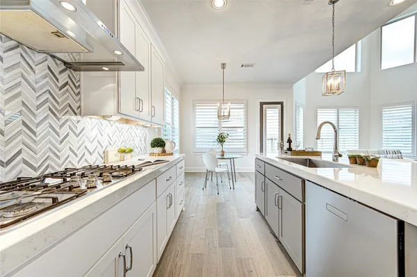 a kitchen with lots of counter top space and wooden floor