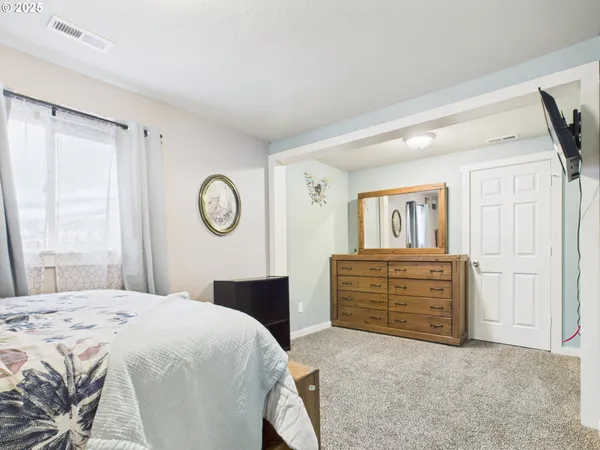 a bedroom with a bed and a dresser