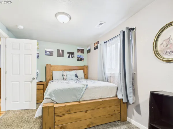 a bedroom with a bed and a view of bathroom