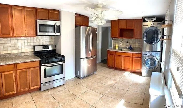 a kitchen with stainless steel appliances granite countertop a refrigerator stove top oven and sink
