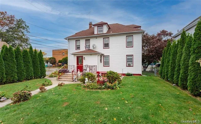 a front view of a house with garden