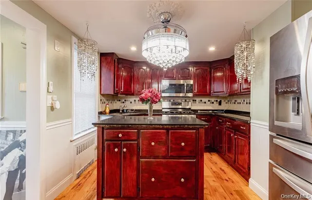 a kitchen with stainless steel appliances granite countertop wooden cabinets and a sink