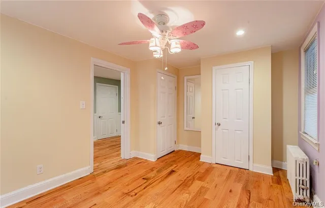 a bedroom with a bed and a chandelier fan