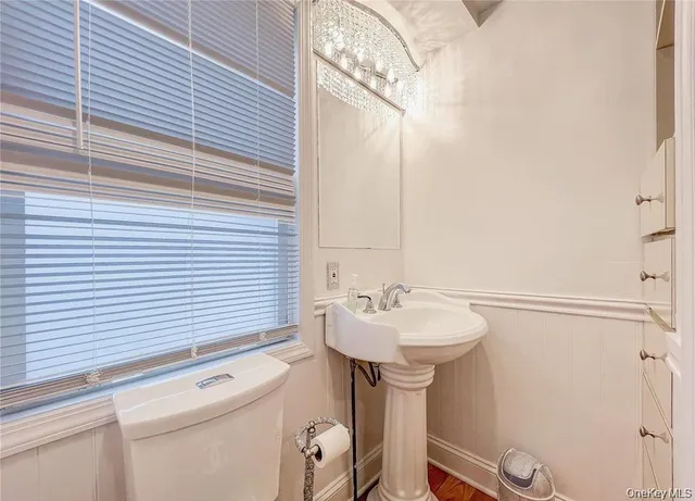 a bathroom with a sink a toilet and mirror