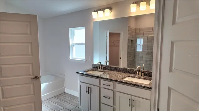 a bathroom with a granite countertop toilet sink and shower
