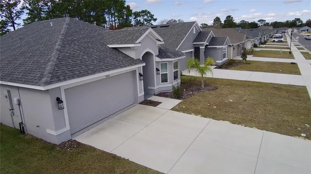 an aerial view of a house with a yard