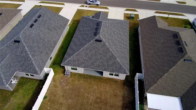 an aerial view of residential house with outdoor space and parking