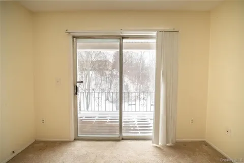 a view of empty room with floor to ceiling window