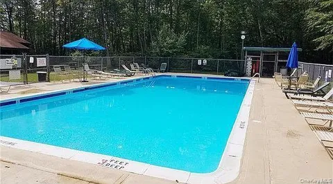 a view of a swimming pool with a patio