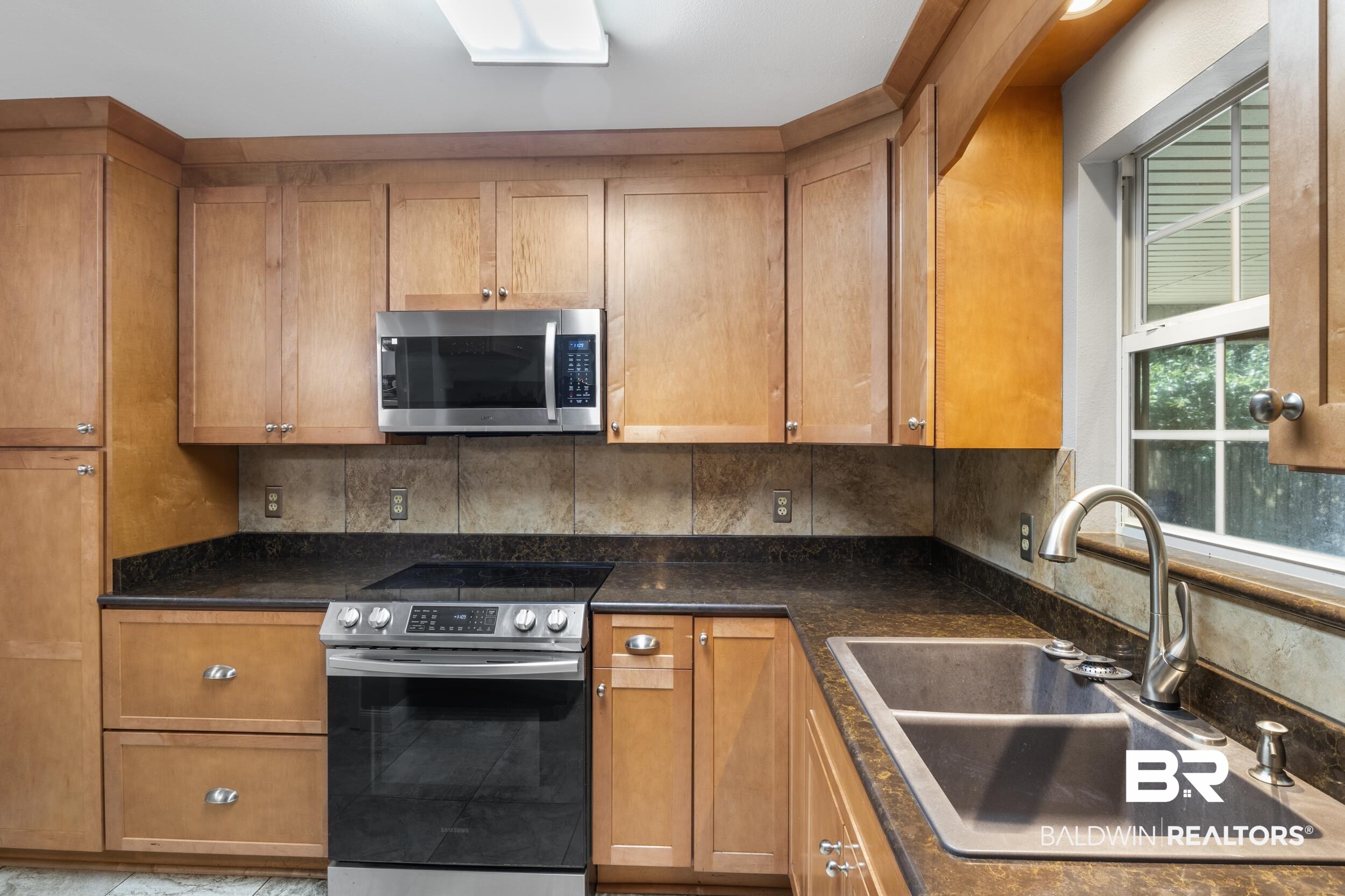 150 Montclair Loop Daphne, AL 36526 - Photo 19 of 29 Kitchen with stainless steel appliances, sink, and backsplash