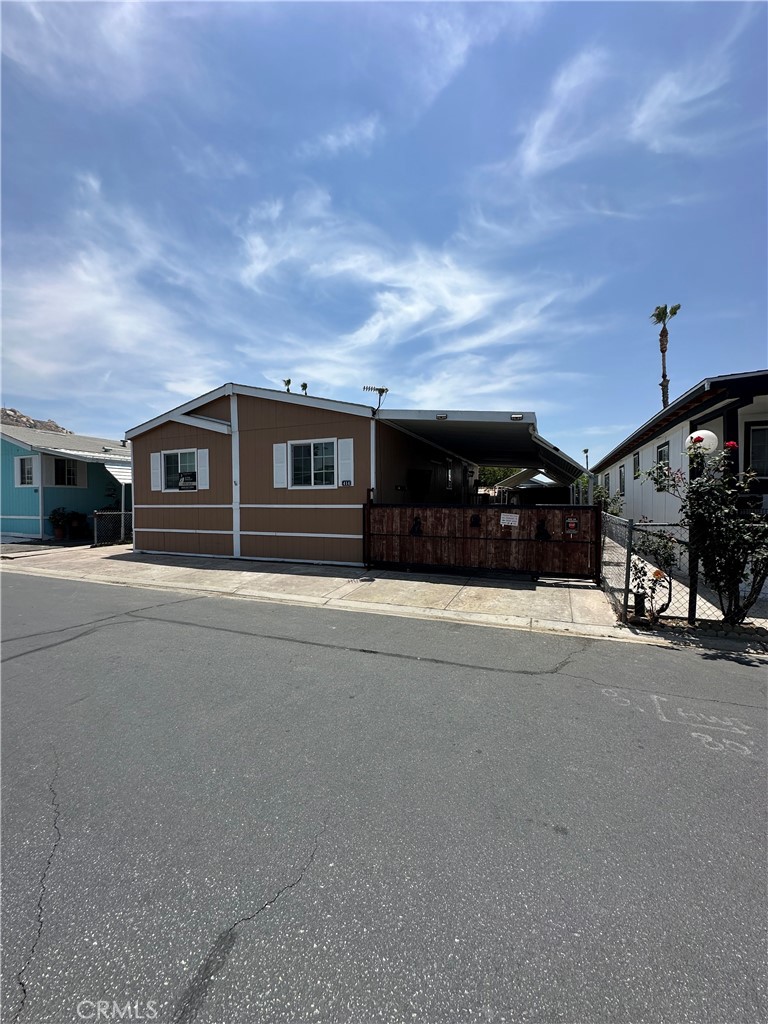 3825 Crestmore Road, Unit 414 Riverside, CA 92509 - Photo 2 of 31 a front view of a house with a yard