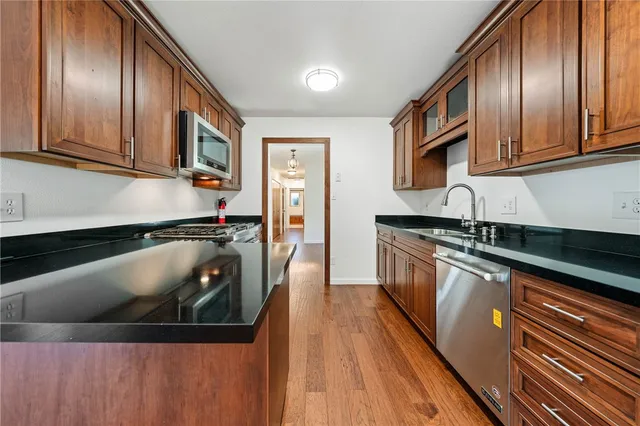 a kitchen with granite countertop a stove and a microwave