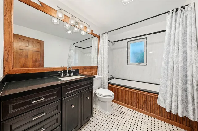 front view of a house with a tree