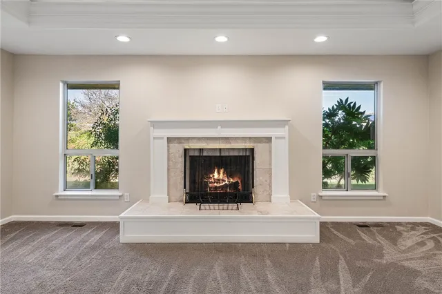 a living room with furniture fireplace and a window