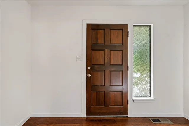 a kitchen with stainless steel appliances granite countertop a sink and wooden cabinets