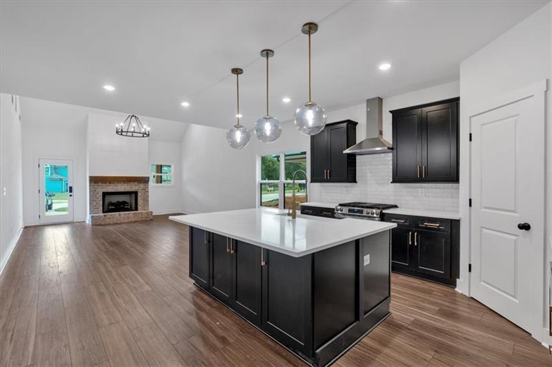 133 Old Alabama Road Southeast Emerson, GA 30137 - Photo 12 of 44 a kitchen with kitchen island granite countertop a sink stove and wooden floor