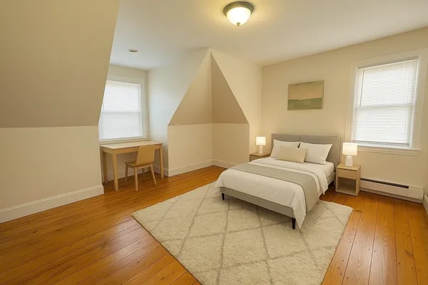 a bedroom with a bed and chair