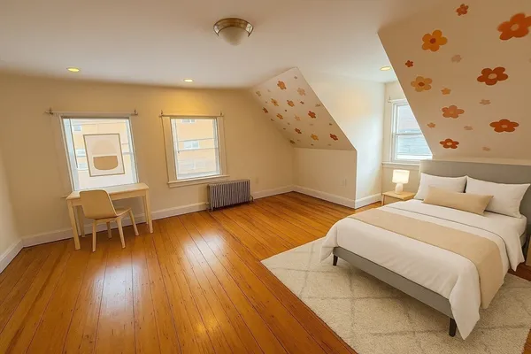 a spacious bedroom with a bed and wooden floor