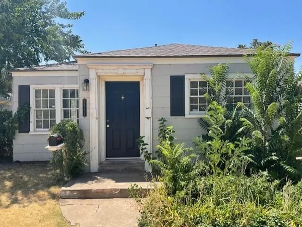 front view of a house with potted plants