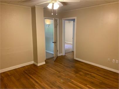 2411 30th Street Lubbock, TX 79411 - Photo 15 of 25 an empty room with wooden floor and mirror