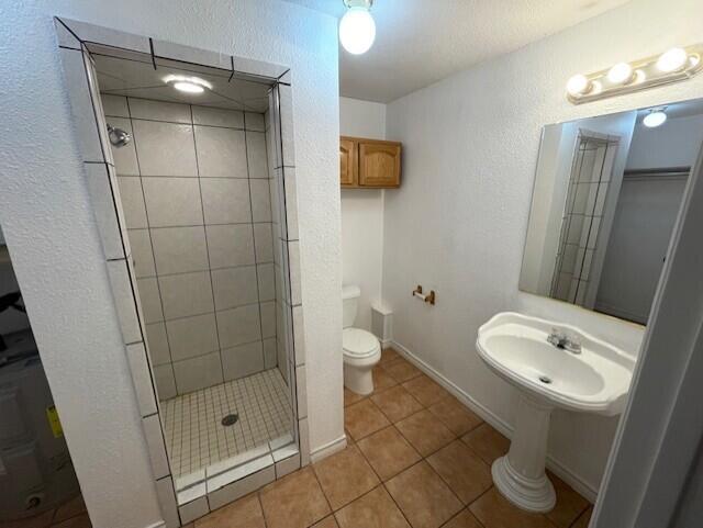 2411 30th Street Lubbock, TX 79411 - Photo 16 of 25 a bathroom with a shower and a toilet sink