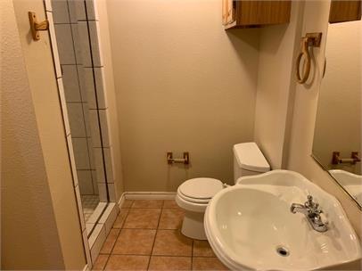 2411 30th Street Lubbock, TX 79411 - Photo 17 of 25 a bathroom with a sink and toilet