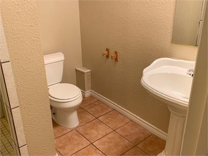 2411 30th Street Lubbock, TX 79411 - Photo 19 of 25 a white toilet sitting next to a shower