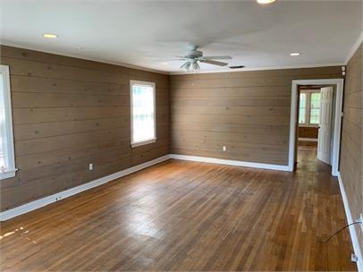 2411 30th Street Lubbock, TX 79411 - Photo 2 of 25 wooden floor in an empty room with a window