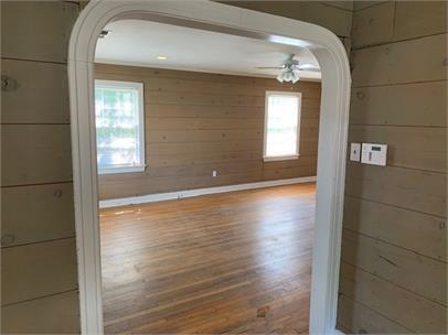 2411 30th Street Lubbock, TX 79411 - Photo 5 of 25 a view of empty room with wooden floor and fan