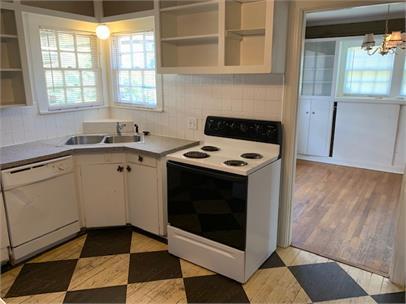 2411 30th Street Lubbock, TX 79411 - Photo 8 of 25 a kitchen with a sink stove and cabinets