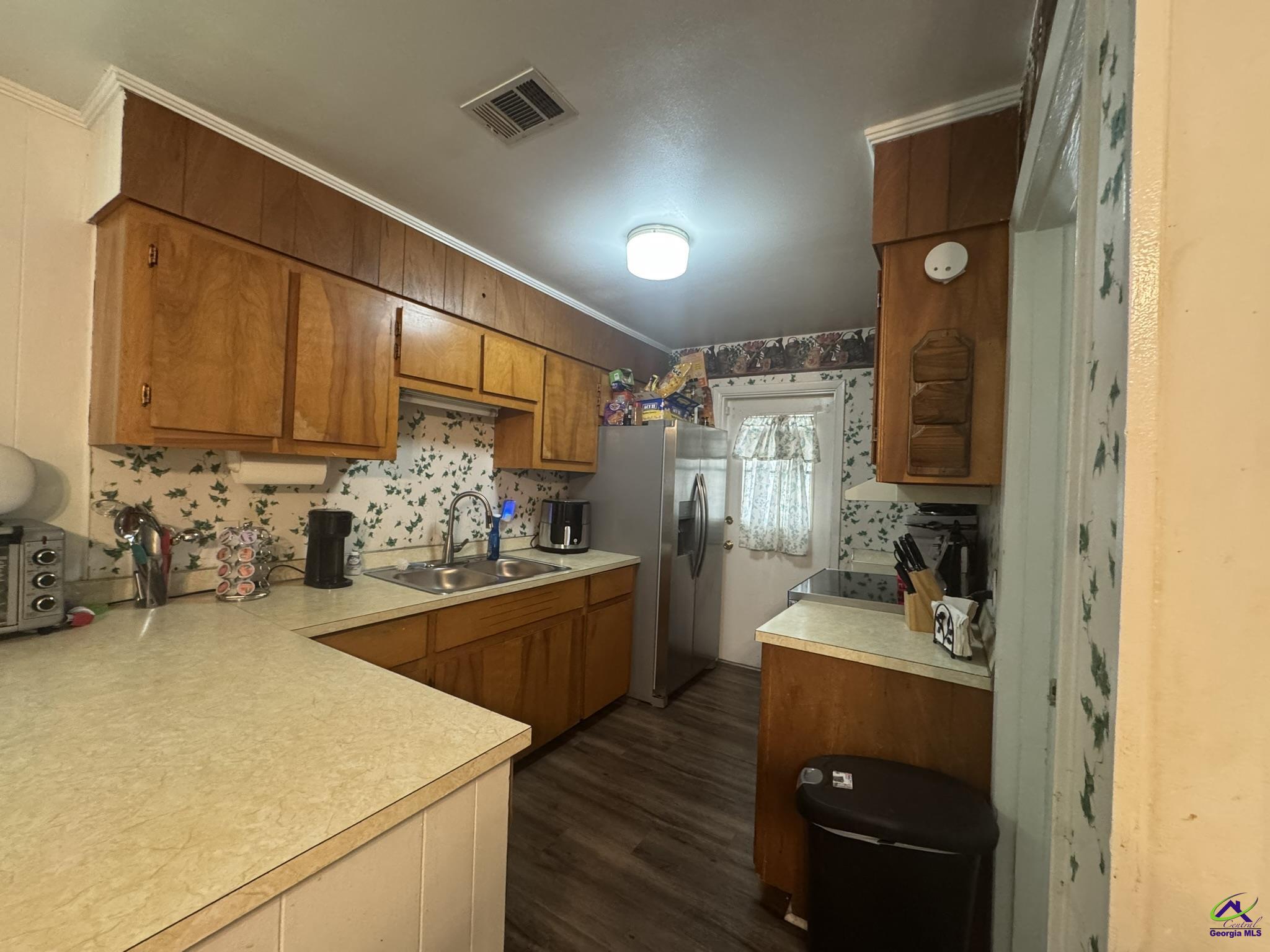 1032 Elberta Road Warner Robins, GA 31093 - Photo 8 of 26 a kitchen with sink cabinets and appliances