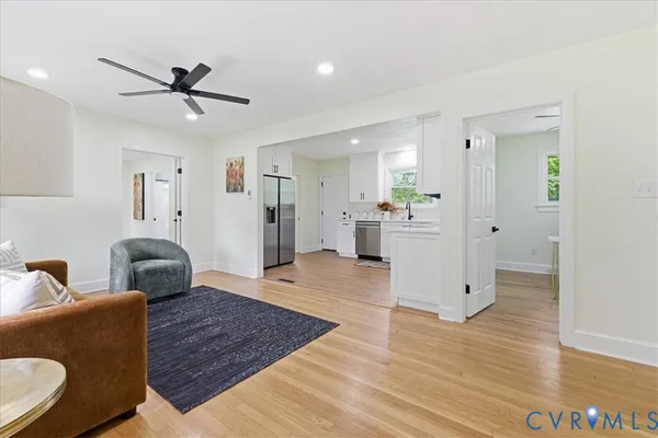 a living room with furniture and a wooden floor