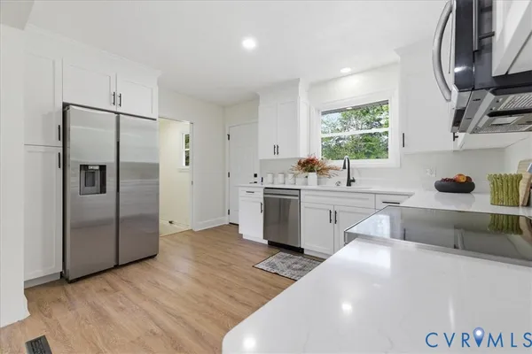 a kitchen with a sink cabinets and stainless steel appliances
