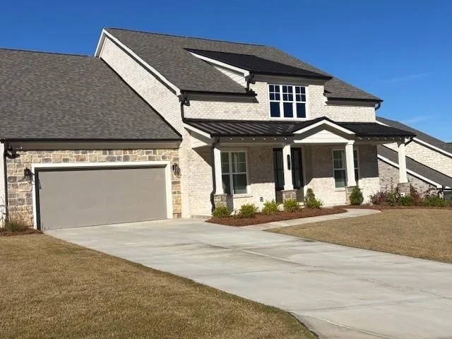a front view of a house with a garden and entryway