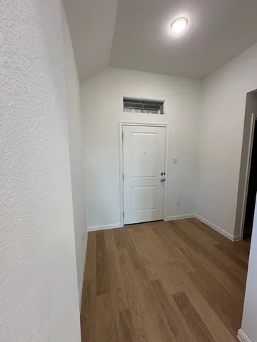 an empty room with wooden door