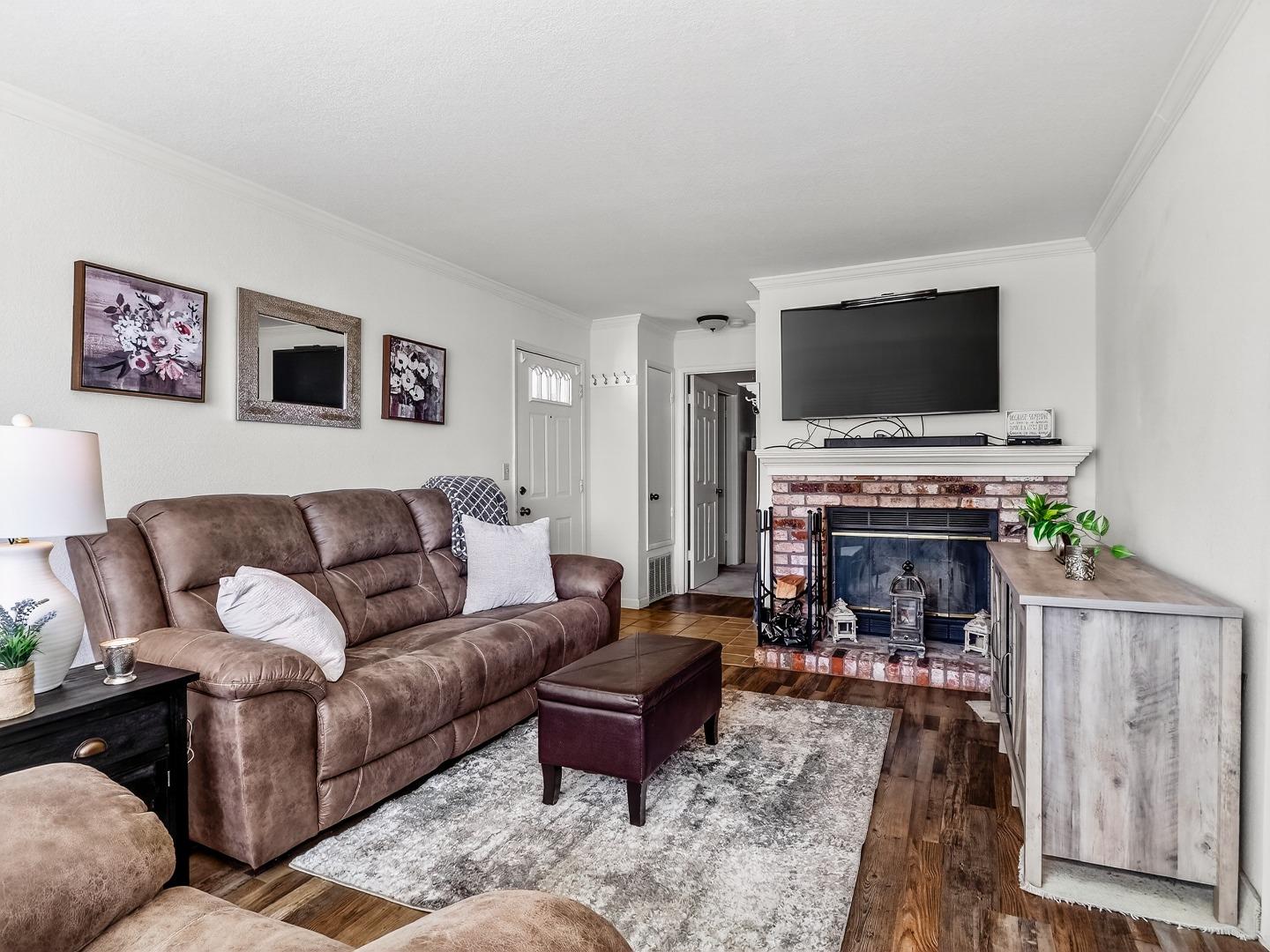 1056 Padre Drive, Unit 8 Salinas, CA 93901 - Photo 13 of 43 a living room with furniture a flat screen tv and a fireplace