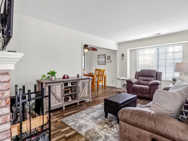 a living room with furniture and wooden floor