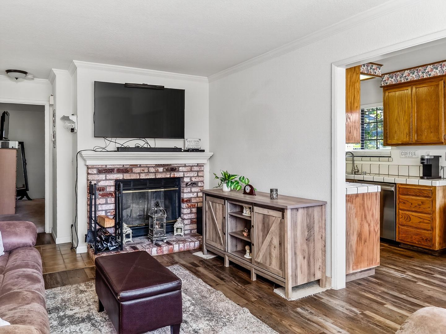 1056 Padre Drive, Unit 8 Salinas, CA 93901 - Photo 17 of 43 a living room with furniture a flat screen tv and a fireplace