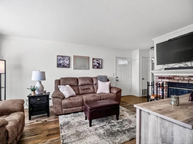 a bedroom with furniture and a wooden floor