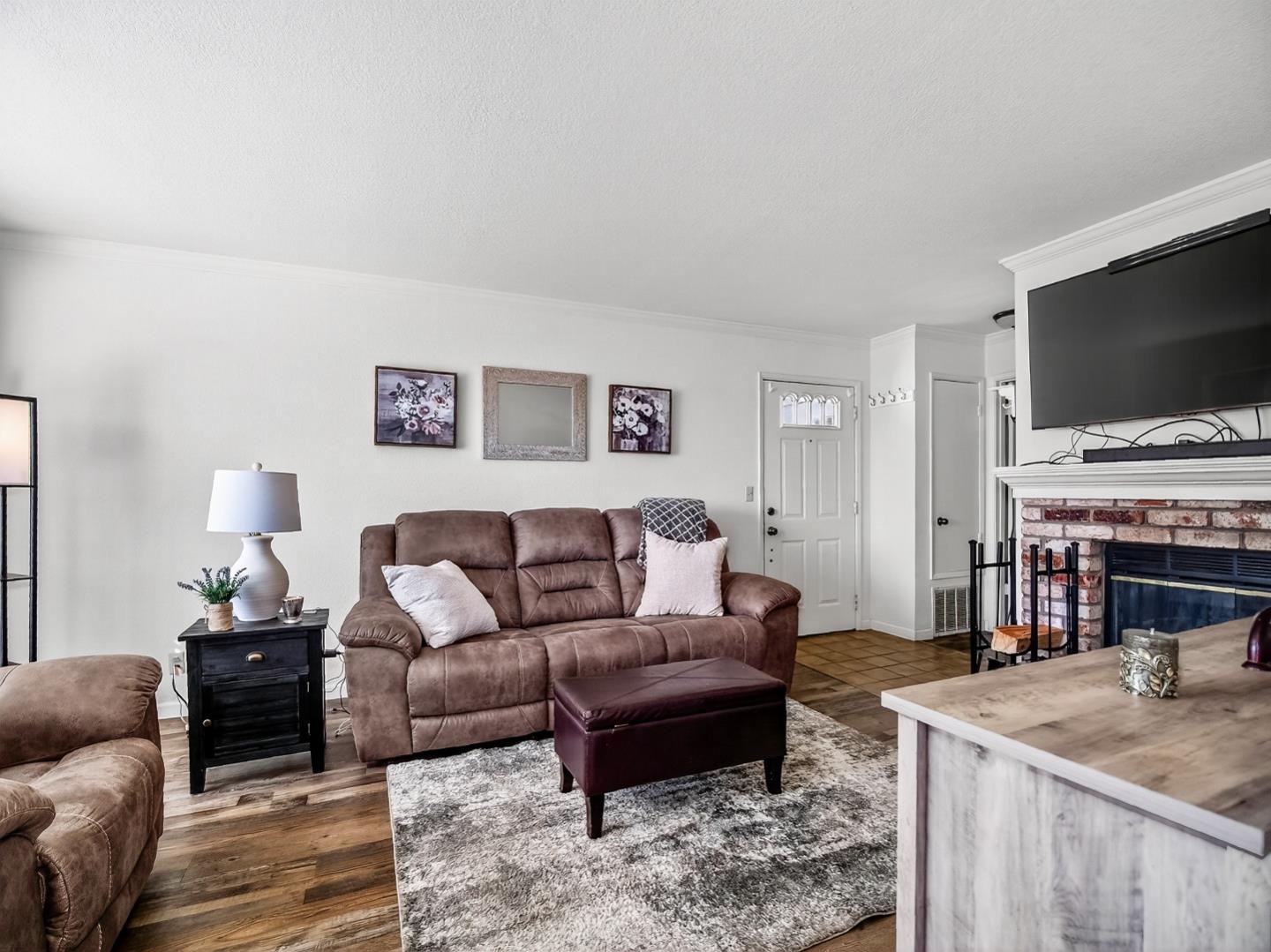 1056 Padre Drive, Unit 8 Salinas, CA 93901 - Photo 19 of 43 a living room with furniture a flat screen tv and a fireplace