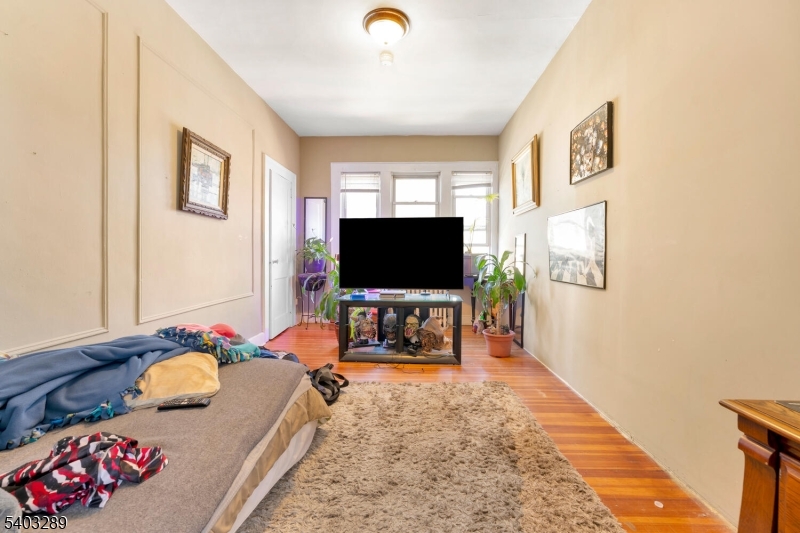 49 Caldwell Place, Unit 5 Springfield, NJ 07081 - Photo 2 of 41 a living room with furniture and a flat screen tv