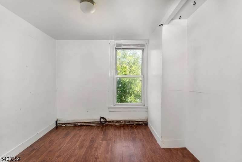 49 Caldwell Place, Unit 5 Springfield, NJ 07081 - Photo 30 of 41 an empty room with wooden floor and windows