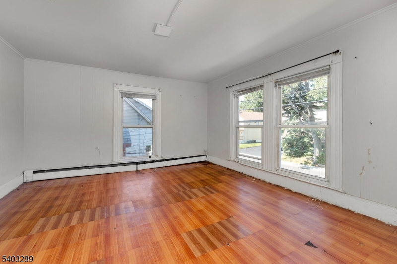 49 Caldwell Place, Unit 5 Springfield, NJ 07081 - Photo 34 of 41 a view of an empty room with wooden floor and a window