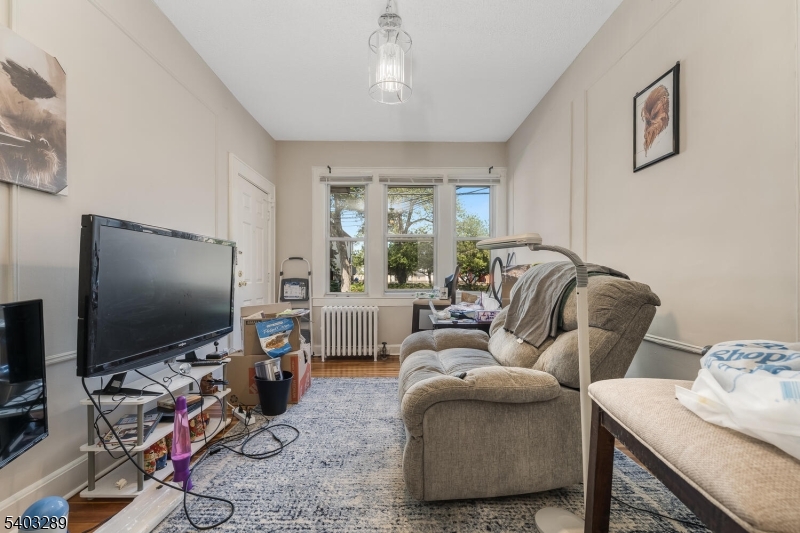 49 Caldwell Place, Unit 5 Springfield, NJ 07081 - Photo 4 of 41 a living room with furniture and a flat screen tv